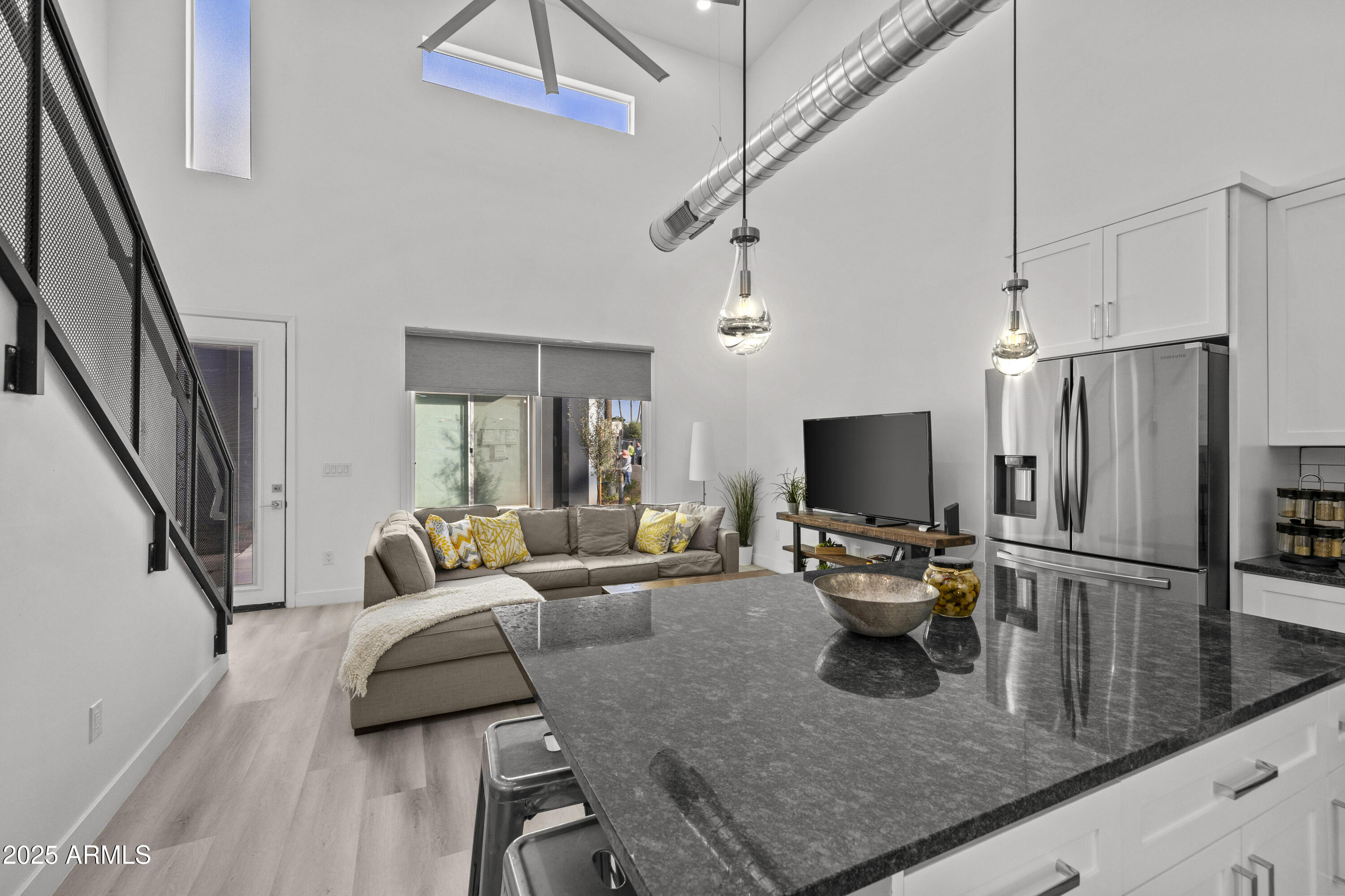 3130 North 37th Street, Unit 13 Phoenix, AZ 85018 - Photo 2 of 15 a living room with furniture and a flat screen tv