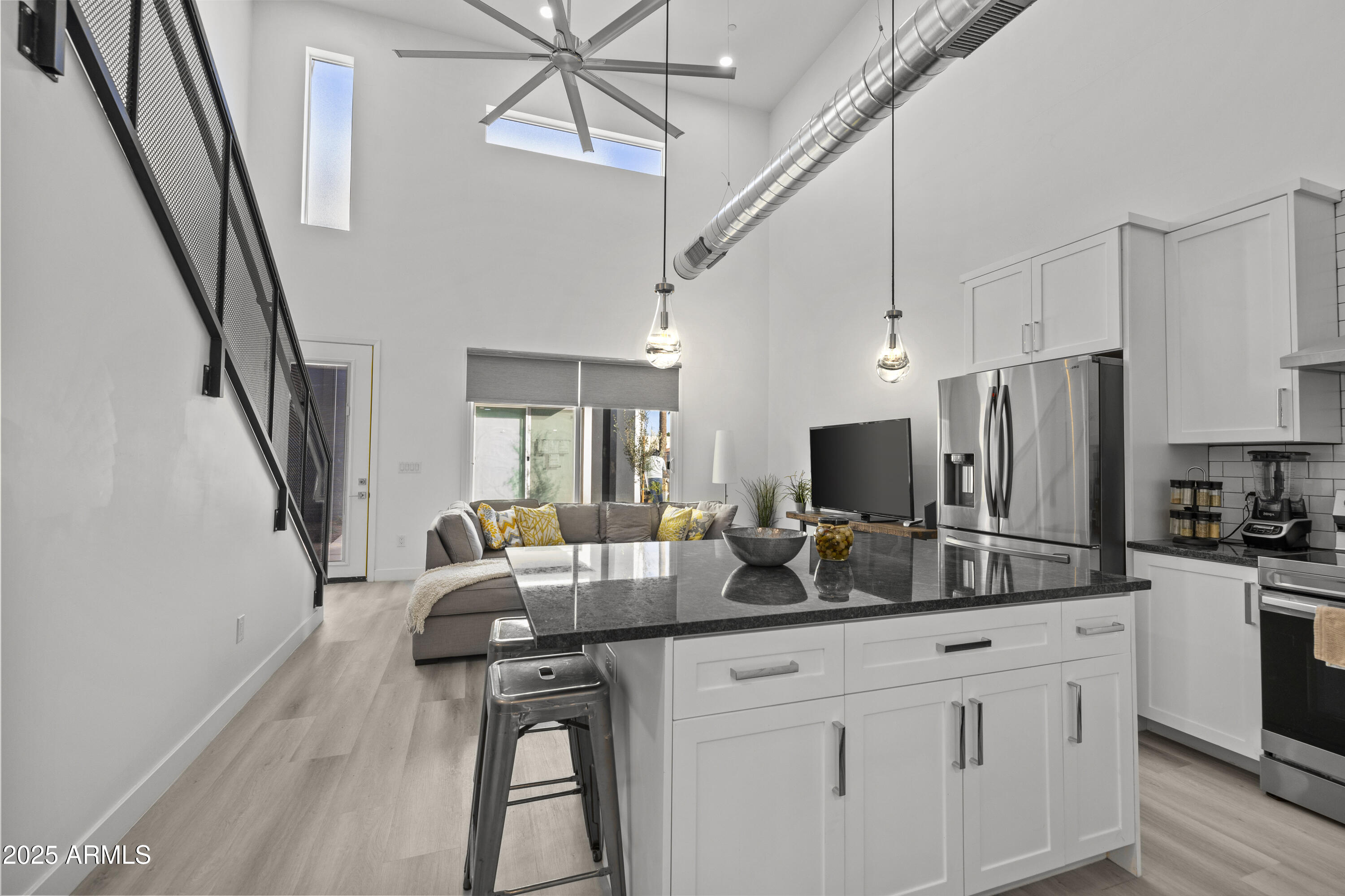 3130 North 37th Street, Unit 13 Phoenix, AZ 85018 - Photo 3 of 15 a kitchen with stainless steel appliances a sink a stove a refrigerator cabinets and wooden floor