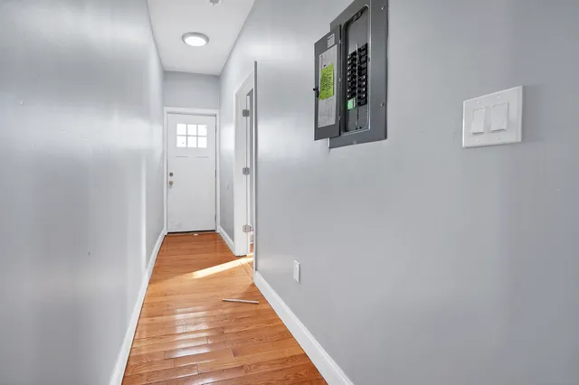 a view of a hallway with wooden floor
