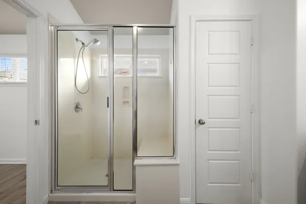 a bathroom with a glass shower door