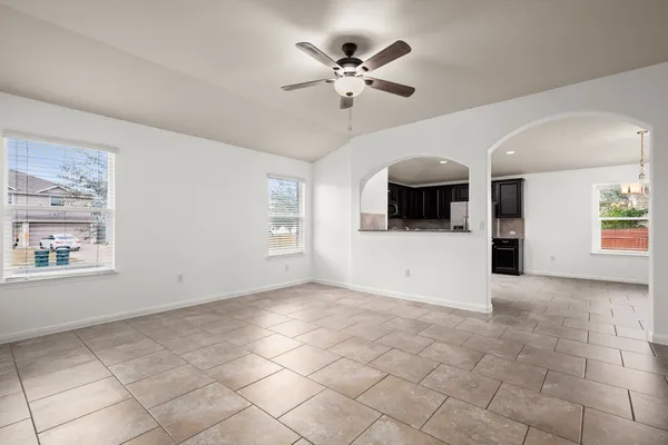 a view of a livingroom with a ceiling fan and window