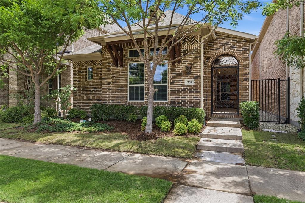 768 Huntingdon Street Coppell, TX 75019 - Photo 33 of 37 The stone pathway, lush greenery, and covered entry create a welcoming approach with classic Texas charm.