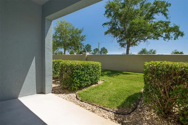 a view of a back yard of the house and a yard