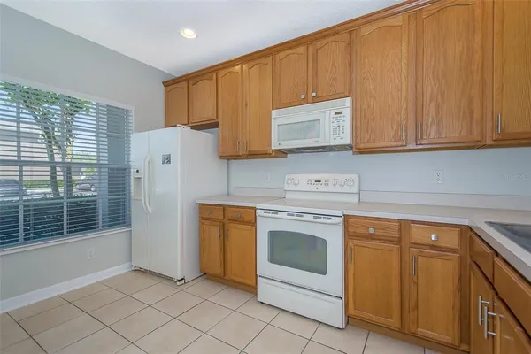 a kitchen with granite countertop cabinets stainless steel appliances and a sink