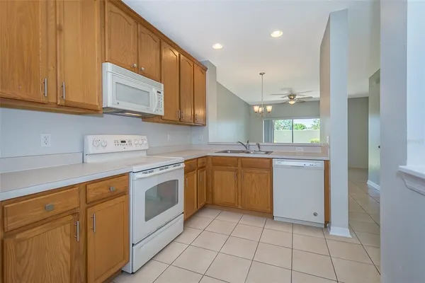 a kitchen with a sink cabinets and window