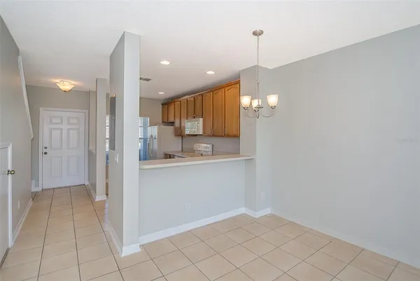 a view of a kitchen with a sink and dishwasher with wooden floor