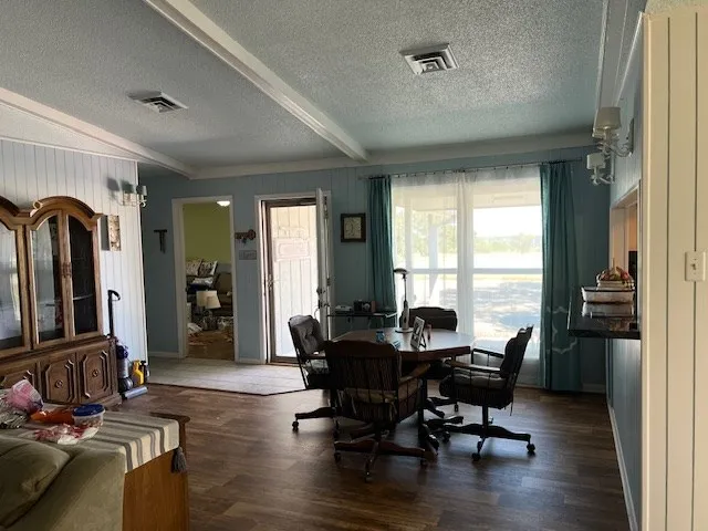 a view of a livingroom with furniture window and wooden floor