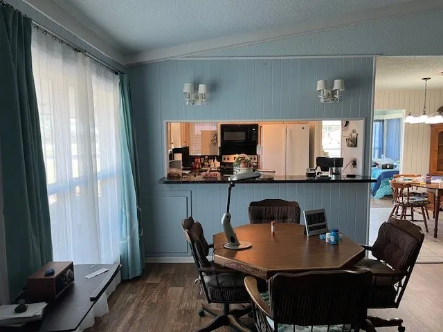 a dining room with furniture and wooden floor