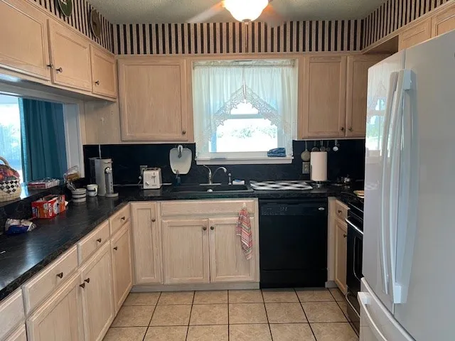 a kitchen with a refrigerator and a stove
