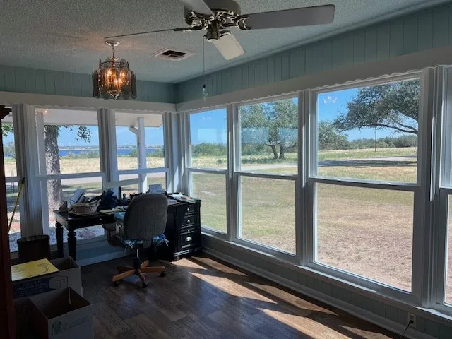 a view of a livingroom with furniture wooden floor and a window