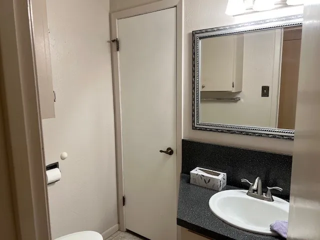 a room with lots of books and a large mirror