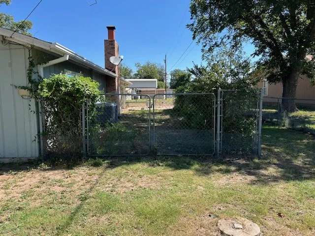 a view of room with wooden floor and a floor to ceiling window