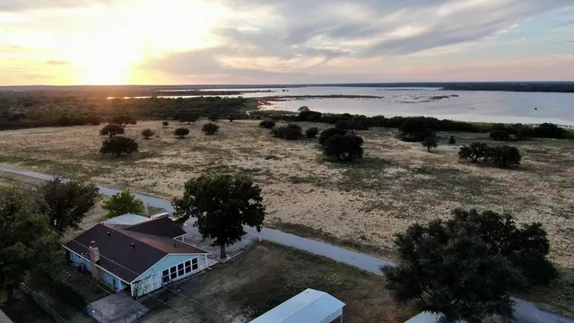 a view of room with wooden floor and a floor to ceiling window