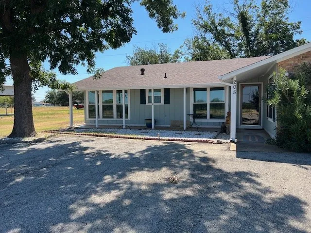 a house with a trees in front of it
