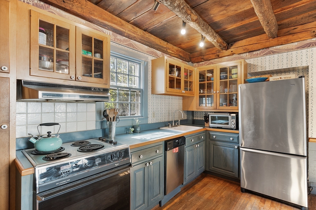 17 Maple Street Sterling, MA 01564 - Photo 16 of 42 a kitchen with stainless steel appliances granite countertop a stove and a refrigerator