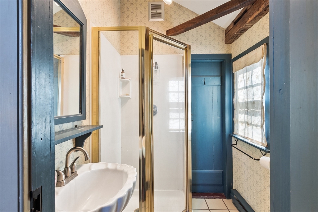 17 Maple Street Sterling, MA 01564 - Photo 31 of 42 a bathroom with a sink and mirror with bathtub