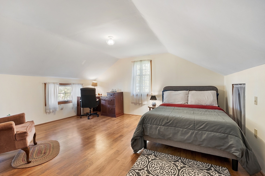 17 Maple Street Sterling, MA 01564 - Photo 37 of 42 a bedroom with a bed and a chair