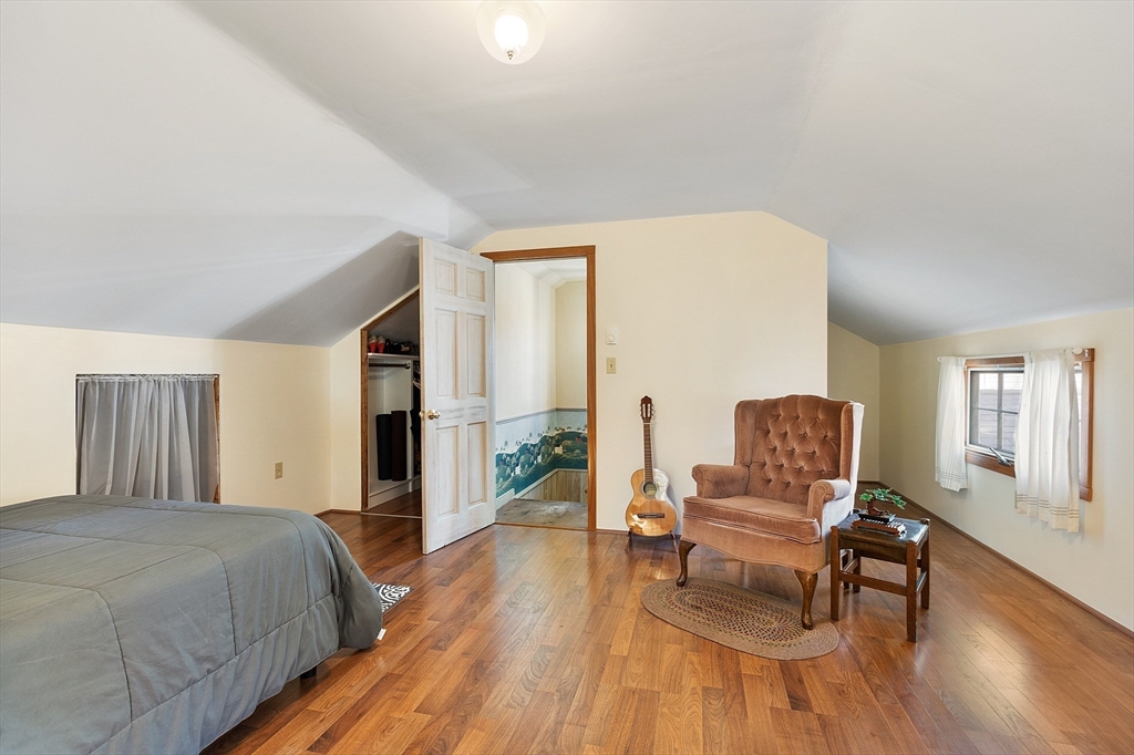 17 Maple Street Sterling, MA 01564 - Photo 38 of 42 a spacious bedroom with a bed and chair