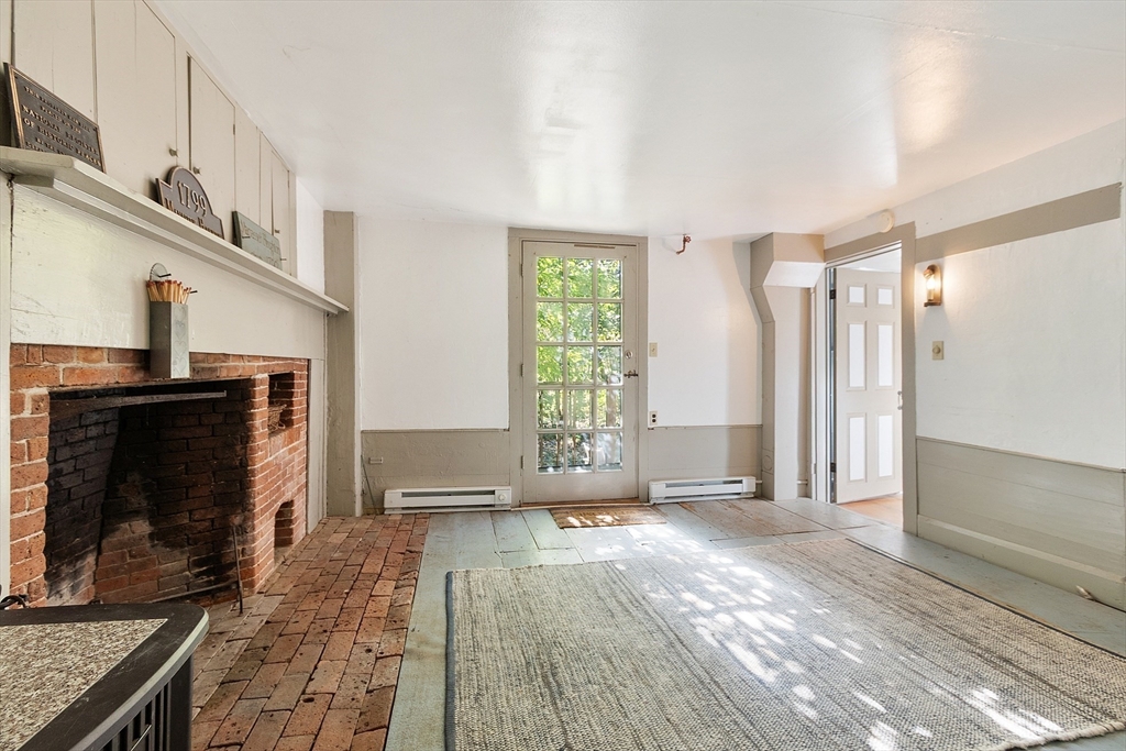 17 Maple Street Sterling, MA 01564 - Photo 40 of 42 a view of an empty room with a fireplace and a window