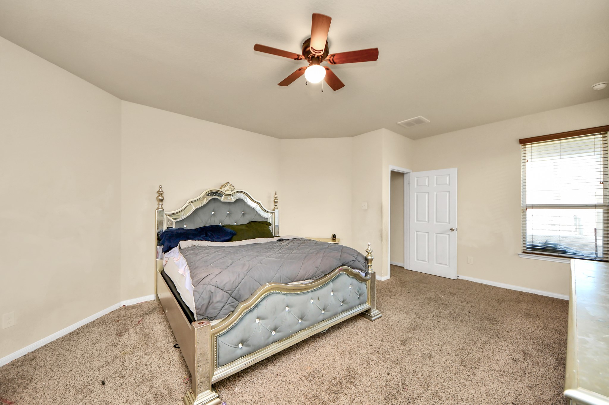 8227 Pastel Dawn Trace Houston, TX 77049 - Photo 11 of 29 a bedroom with a bed and window