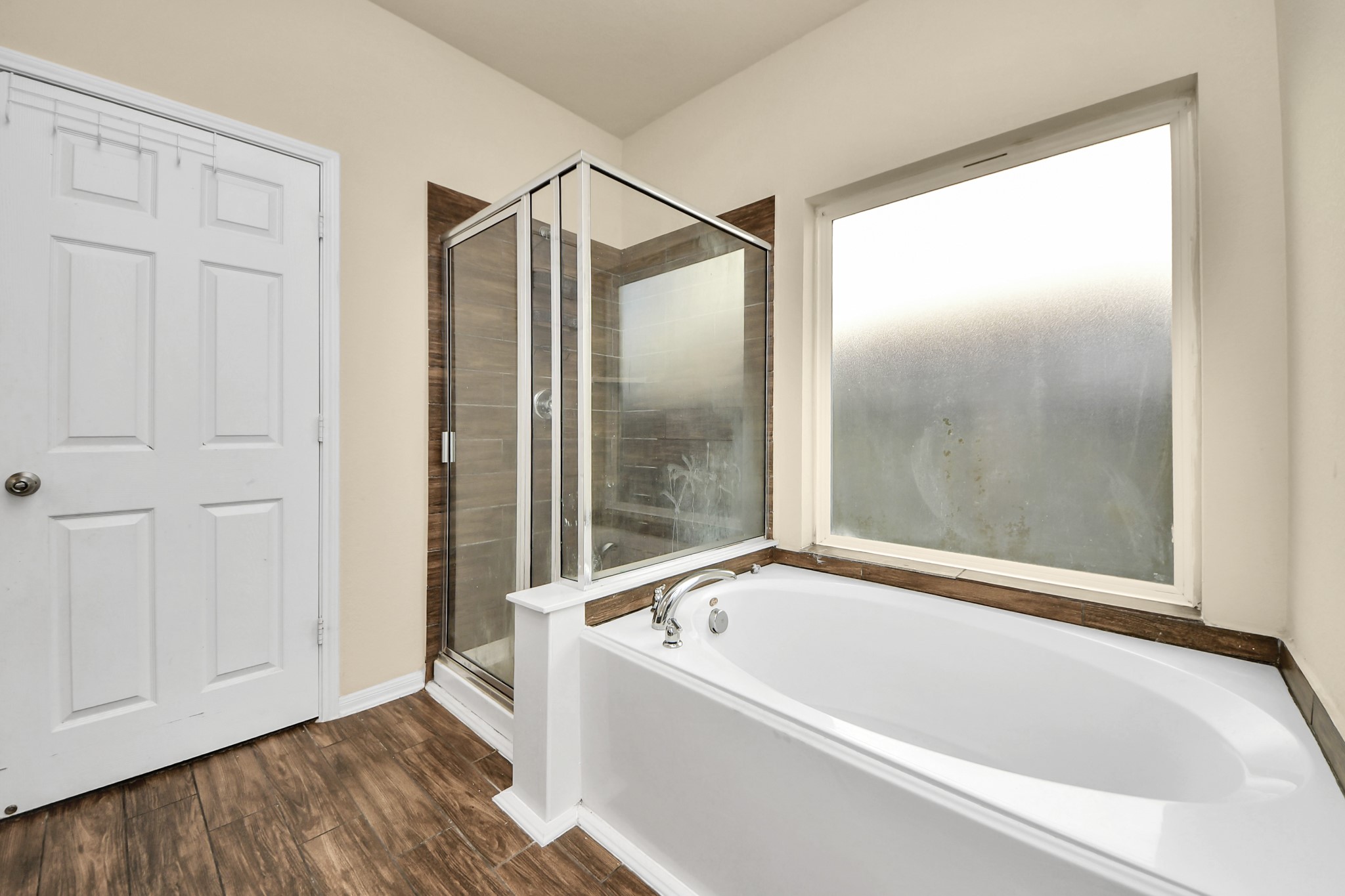 8227 Pastel Dawn Trace Houston, TX 77049 - Photo 12 of 29 a bathroom with a bathtub and a shower