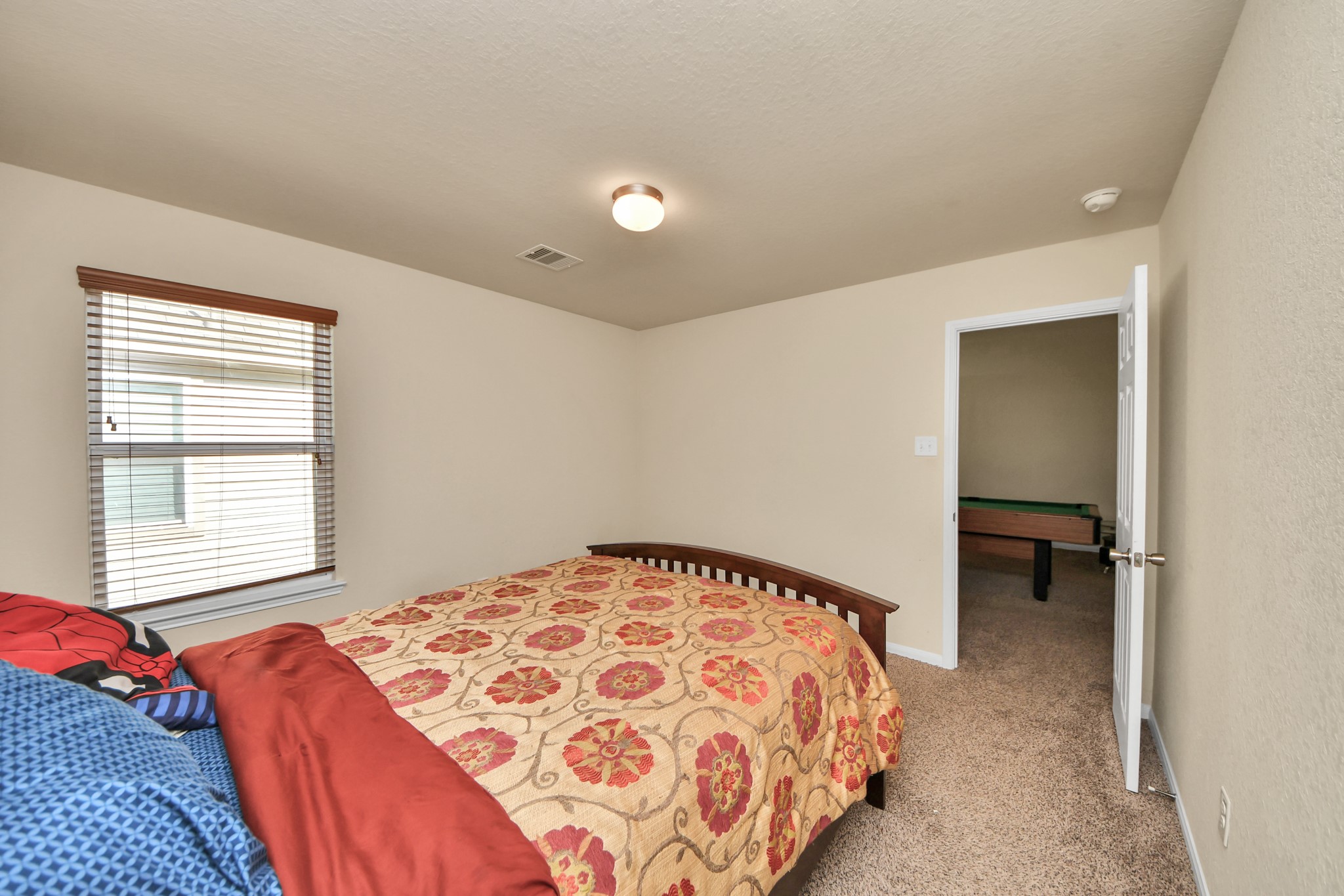 8227 Pastel Dawn Trace Houston, TX 77049 - Photo 18 of 29 a bedroom with a bed and a window