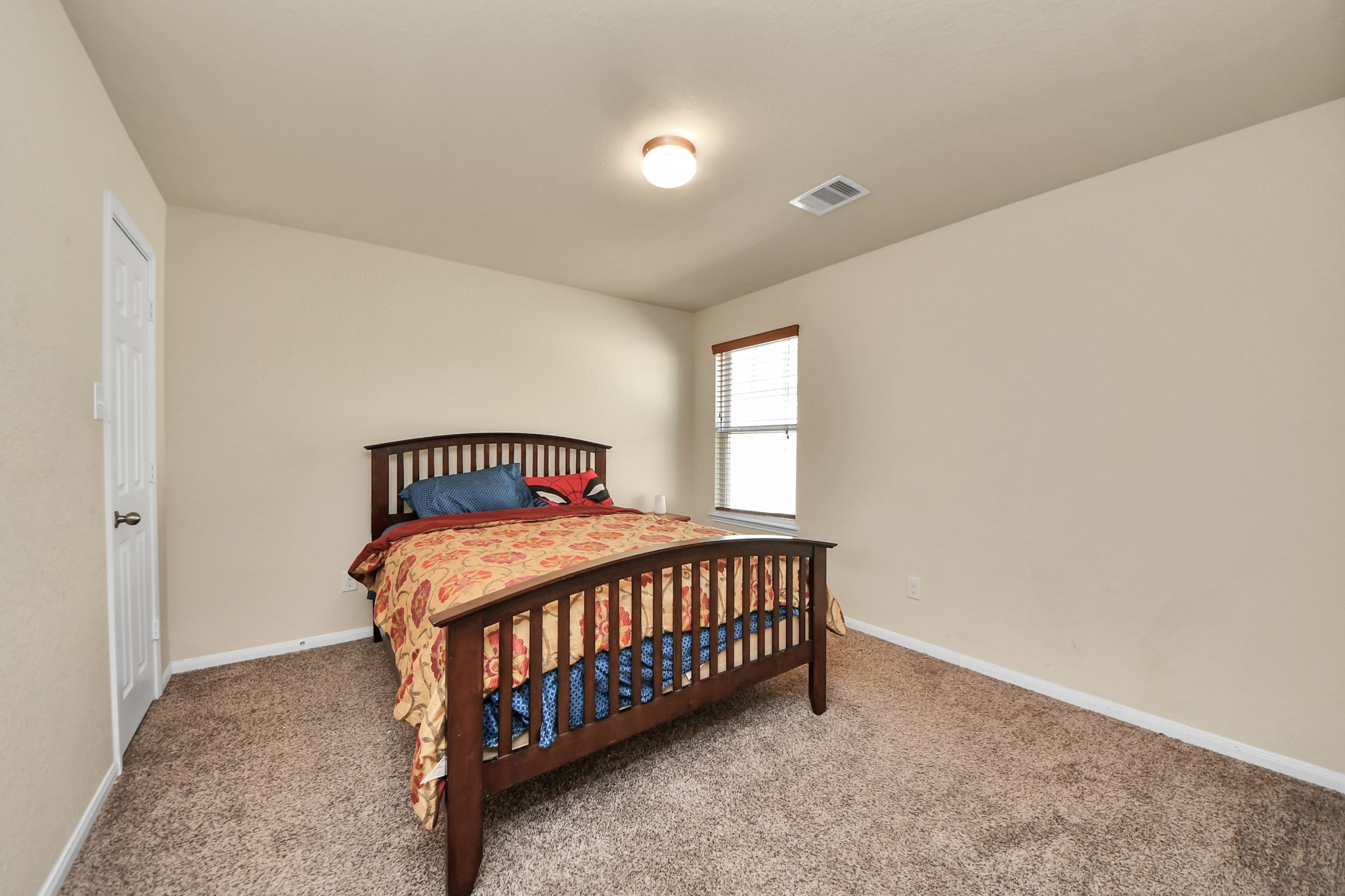 8227 Pastel Dawn Trace Houston, TX 77049 - Photo 19 of 29 a bedroom with a bed and a window