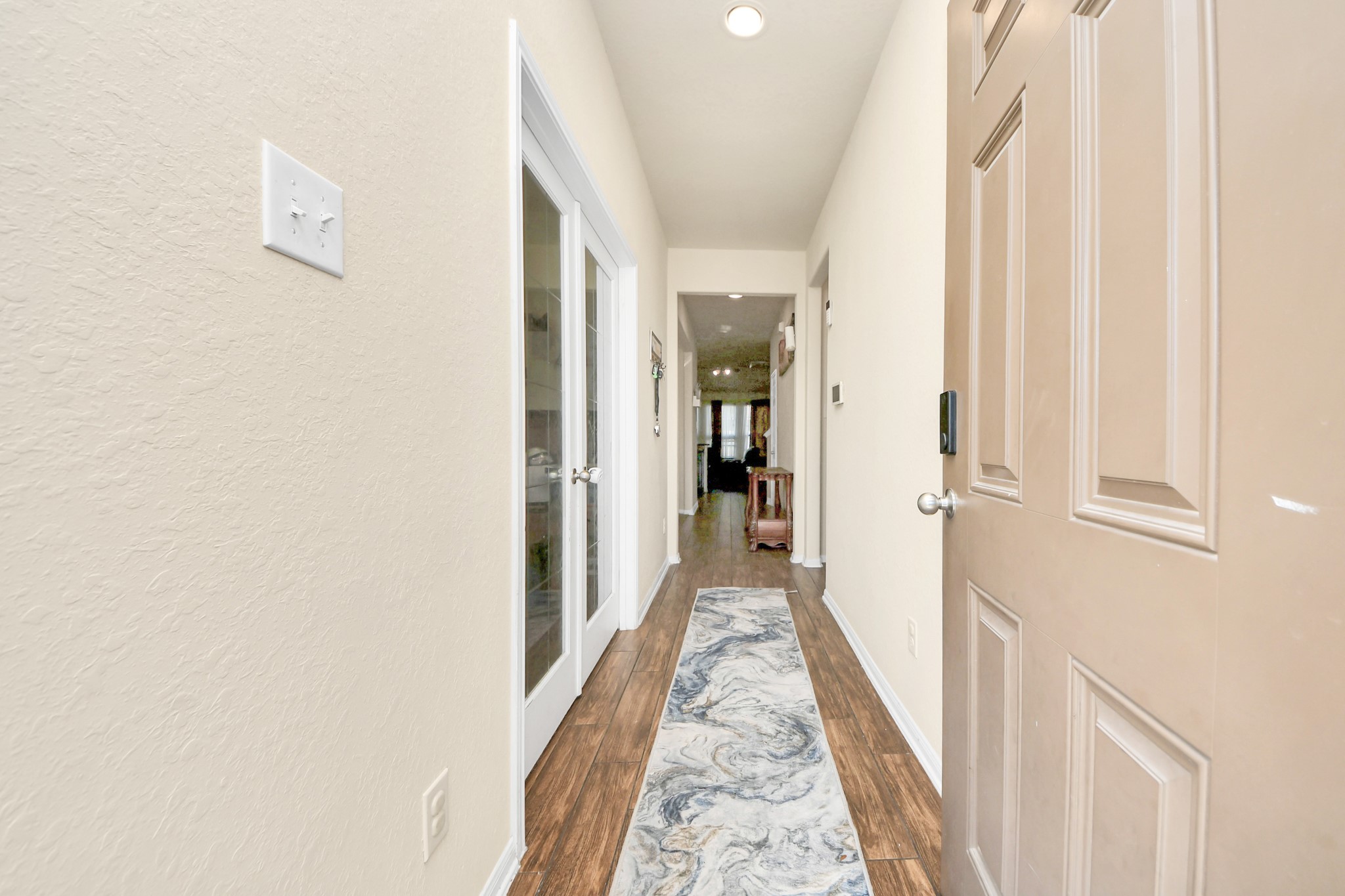 8227 Pastel Dawn Trace Houston, TX 77049 - Photo 2 of 29 a view of a hallway with a white walls and stairs