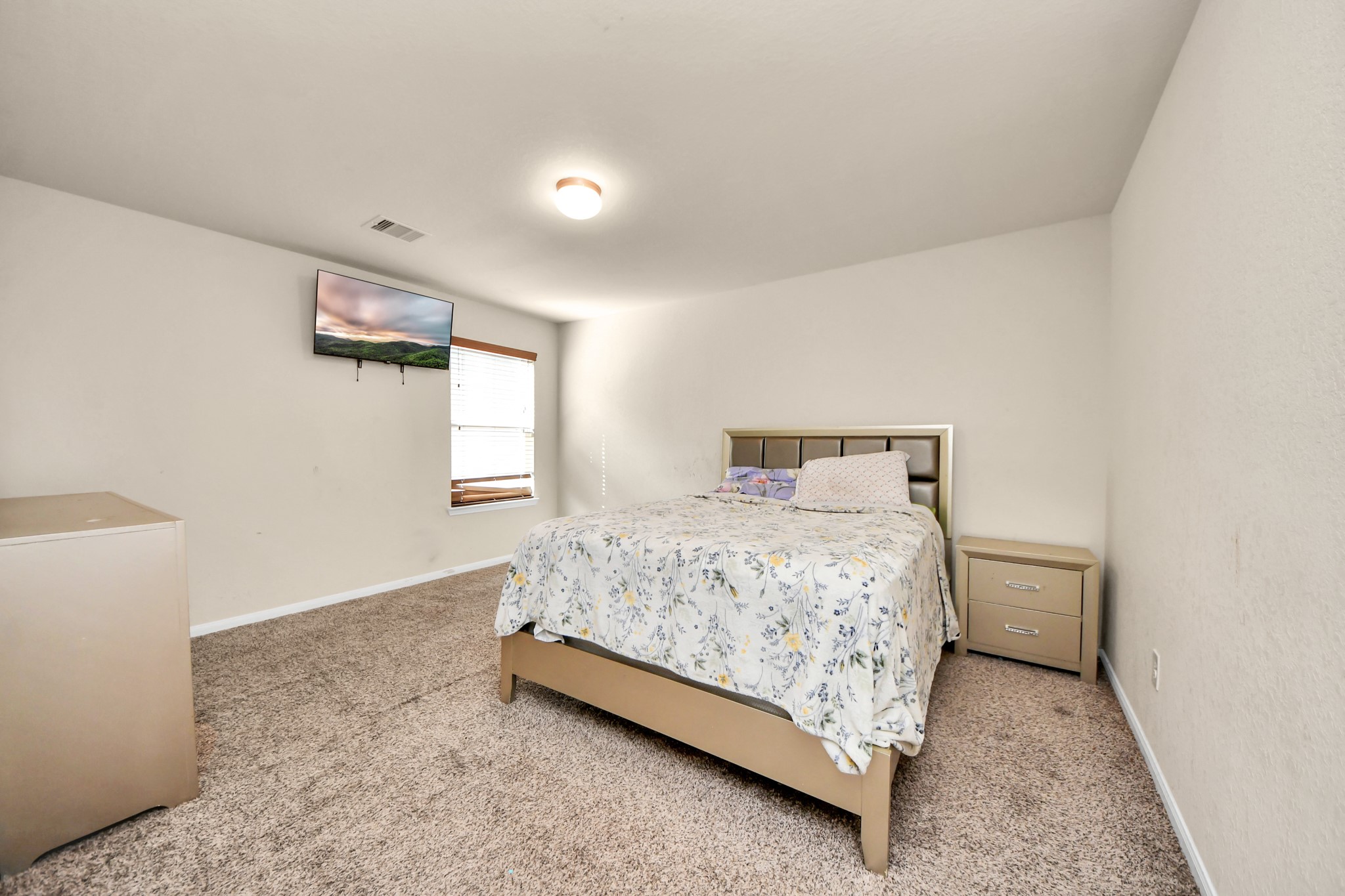 8227 Pastel Dawn Trace Houston, TX 77049 - Photo 22 of 29 a bedroom with a bed and window