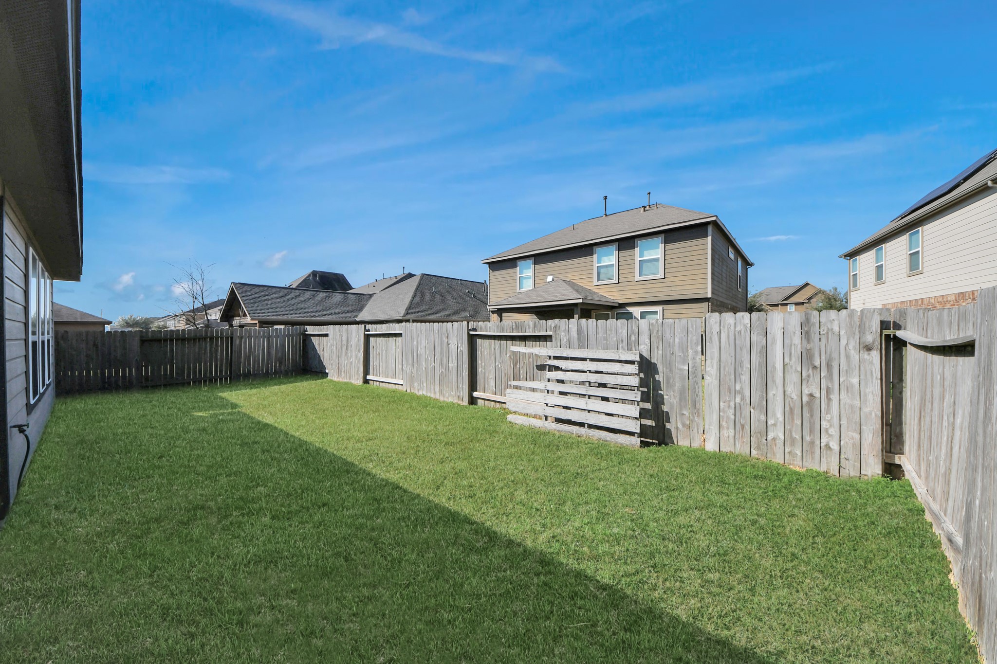 8227 Pastel Dawn Trace Houston, TX 77049 - Photo 25 of 29 a front view of a house with a yard