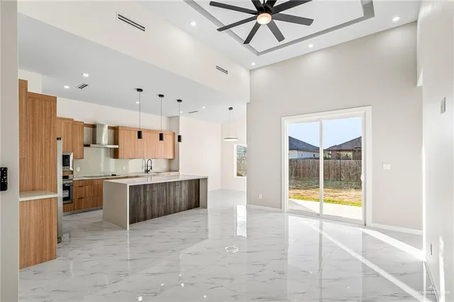 a large white kitchen with a large window cabinets and stainless steel appliances