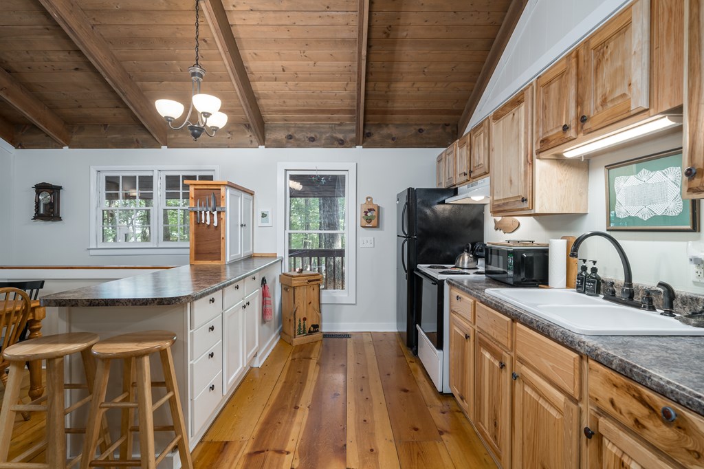131 Hickory Trace Ellijay, GA 30536 - Photo 24 of 67 a kitchen with stainless steel appliances granite countertop a sink a stove and a wooden floors