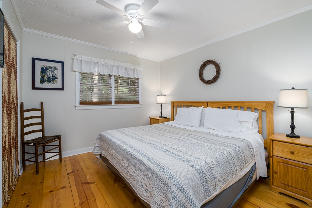 131 Hickory Trace Ellijay, GA 30536 - Photo 28 of 67 a bedroom with a bed and a chandelier