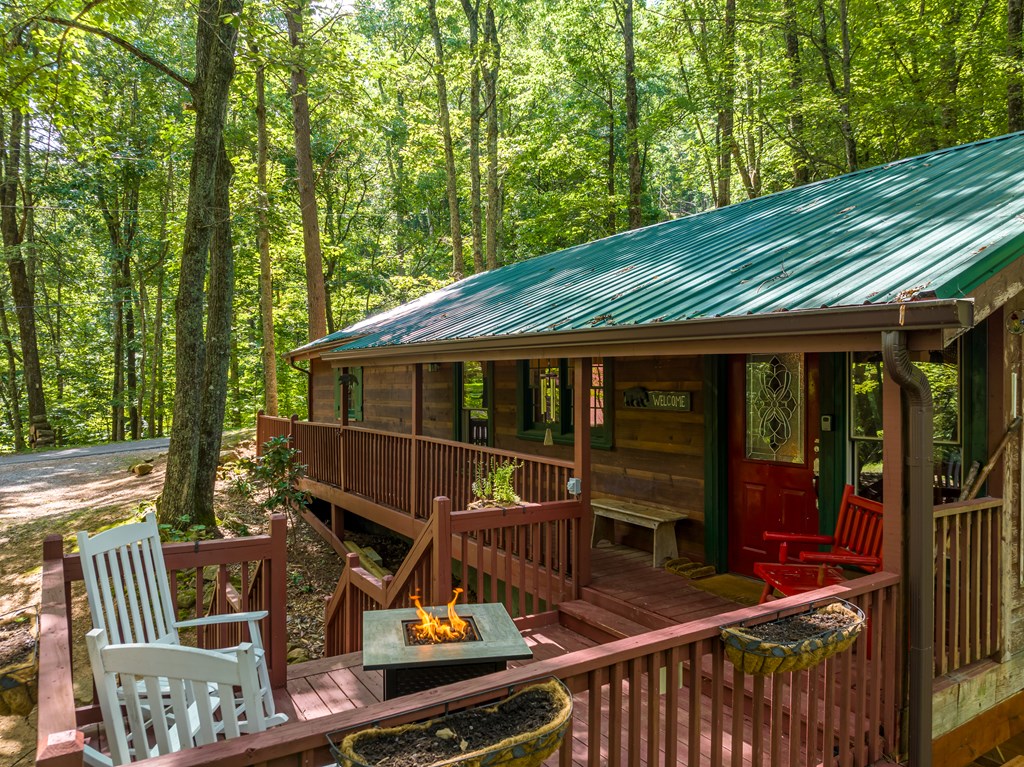 131 Hickory Trace Ellijay, GA 30536 - Photo 5 of 67 a view of a roof deck with table and chairs with wooden floor and fence
