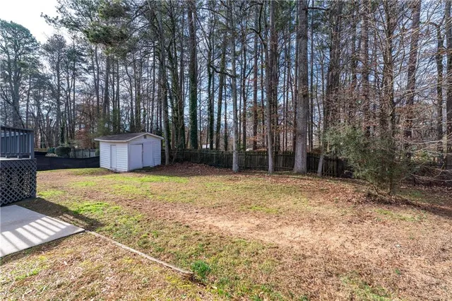 a view of a house with wooden deck front of house