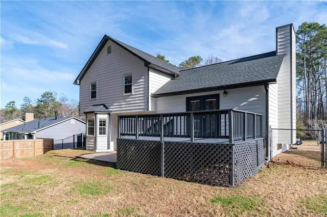 a backyard of a house with table and chairs