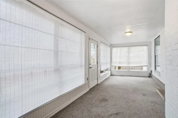 a view of an empty room and a window