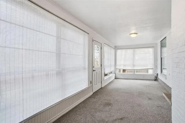 a view of an empty room and a window