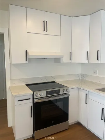 a stove top oven sitting inside of a kitchen