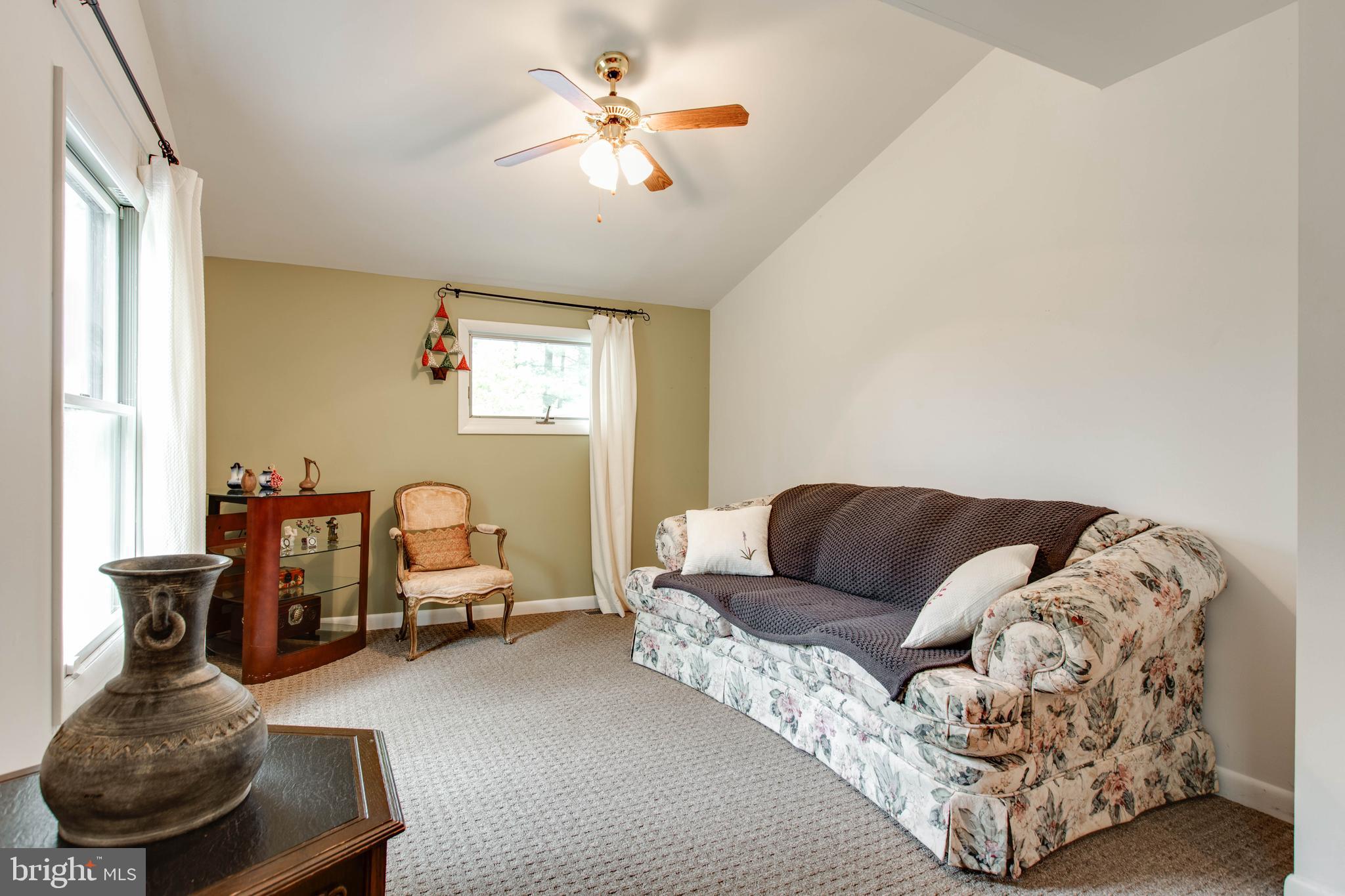 5519 Woodbine Road Sykesville, MD 21784 - Photo 34 of 69 a living room with furniture and a chandelier