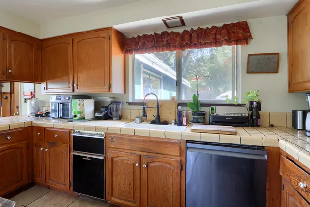 a kitchen with a sink and a stove top oven