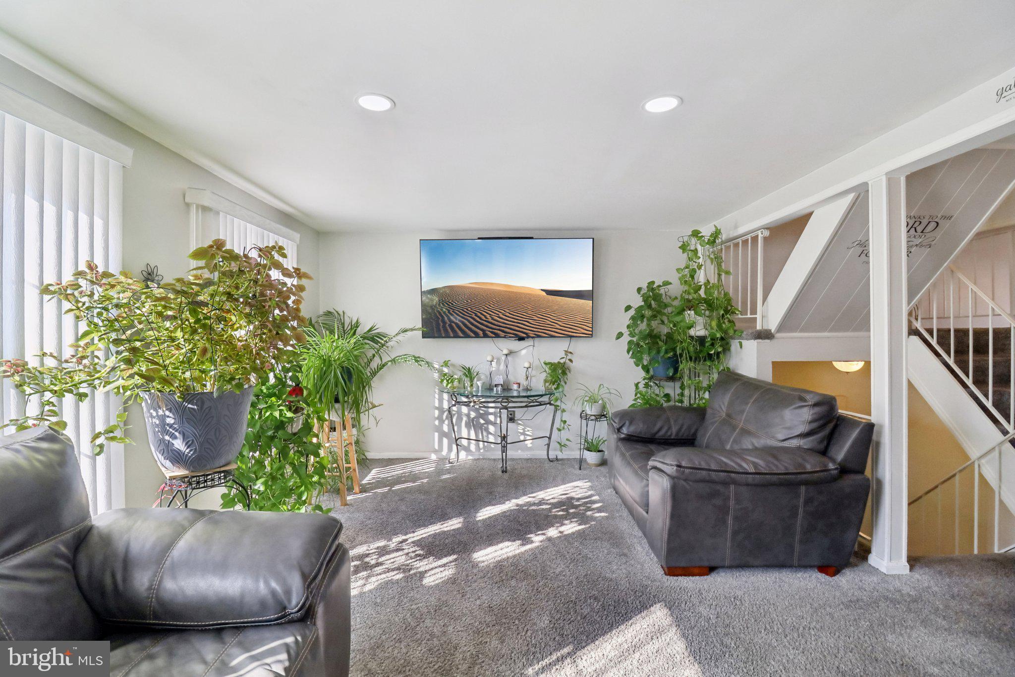 1456 Potomac Heights Drive, Unit 145 Fort Washington, MD 20744 - Photo 11 of 50 a living room with furniture potted plant and a window