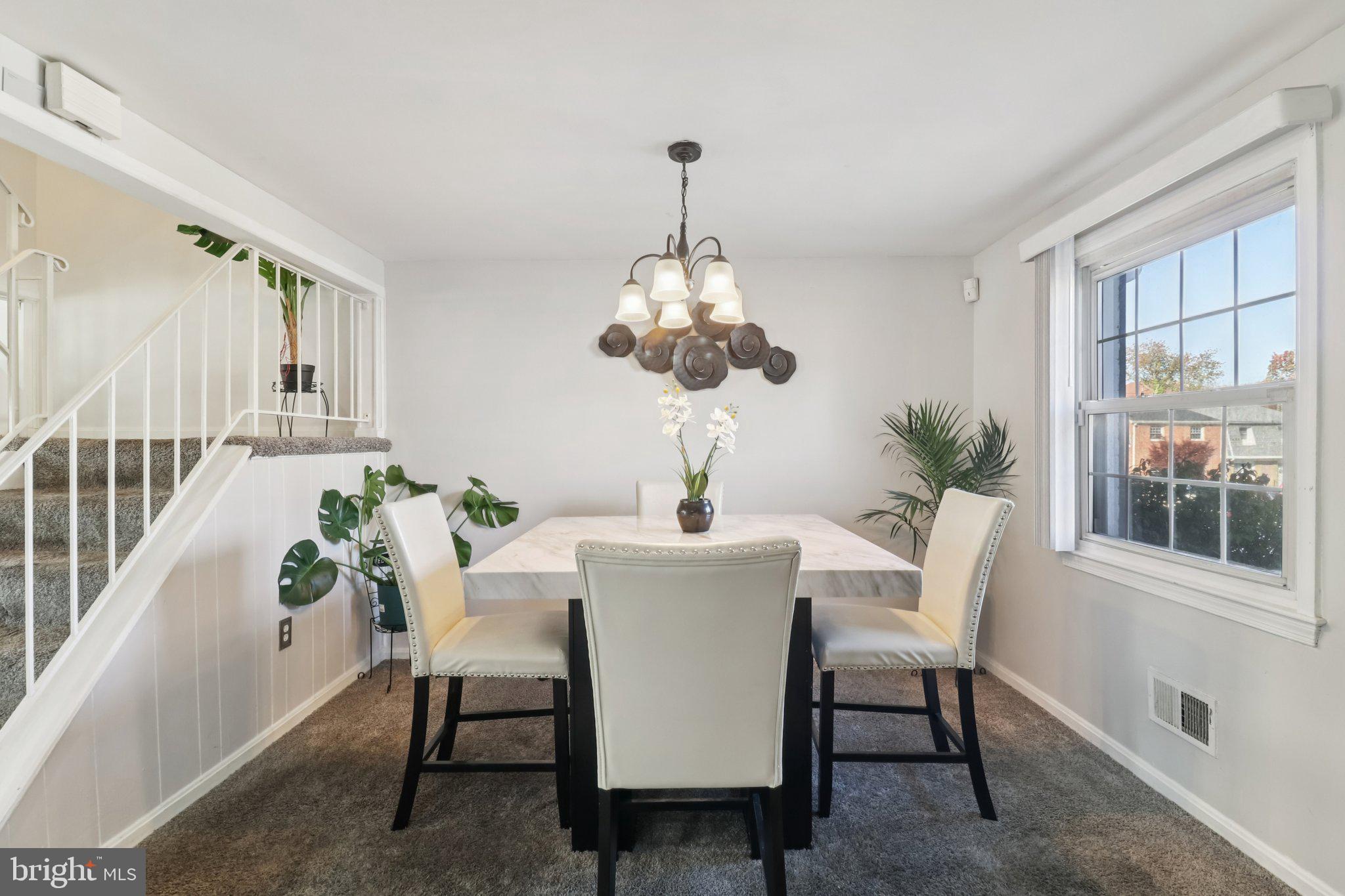 1456 Potomac Heights Drive, Unit 145 Fort Washington, MD 20744 - Photo 12 of 50 a dining room with furniture potted plants and wooden floor