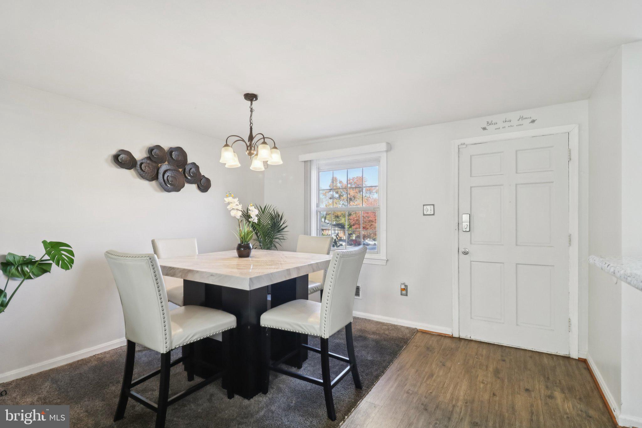 1456 Potomac Heights Drive, Unit 145 Fort Washington, MD 20744 - Photo 13 of 50 a dining room with furniture potted plants and wooden floor