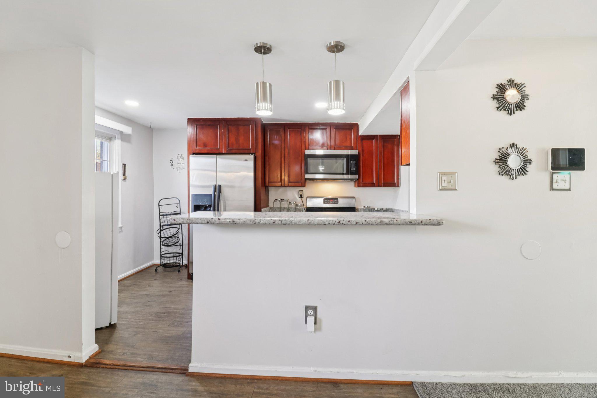 1456 Potomac Heights Drive, Unit 145 Fort Washington, MD 20744 - Photo 14 of 50 a kitchen with stainless steel appliances a refrigerator sink and microwave