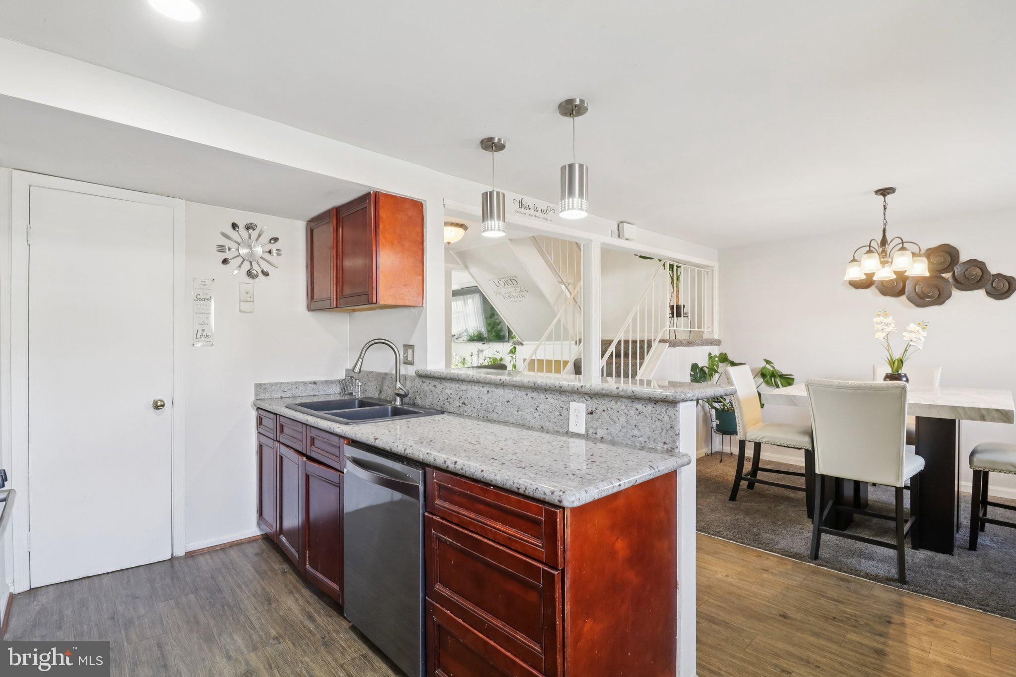 1456 Potomac Heights Drive, Unit 145 Fort Washington, MD 20744 - Photo 16 of 50 a kitchen with stainless steel appliances granite countertop a sink stove and wooden floor