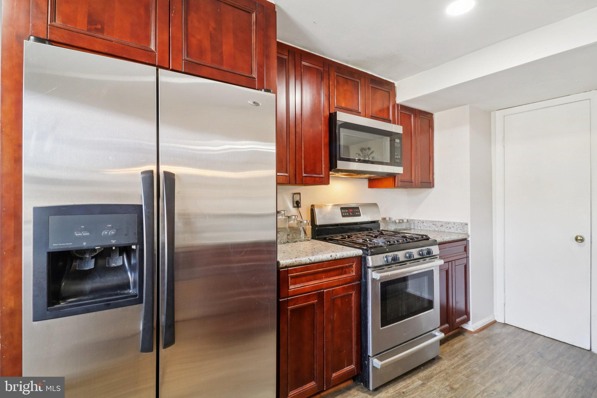 1456 Potomac Heights Drive, Unit 145 Fort Washington, MD 20744 - Photo 18 of 50 a kitchen with stainless steel appliances granite countertop a stove a refrigerator and a microwave
