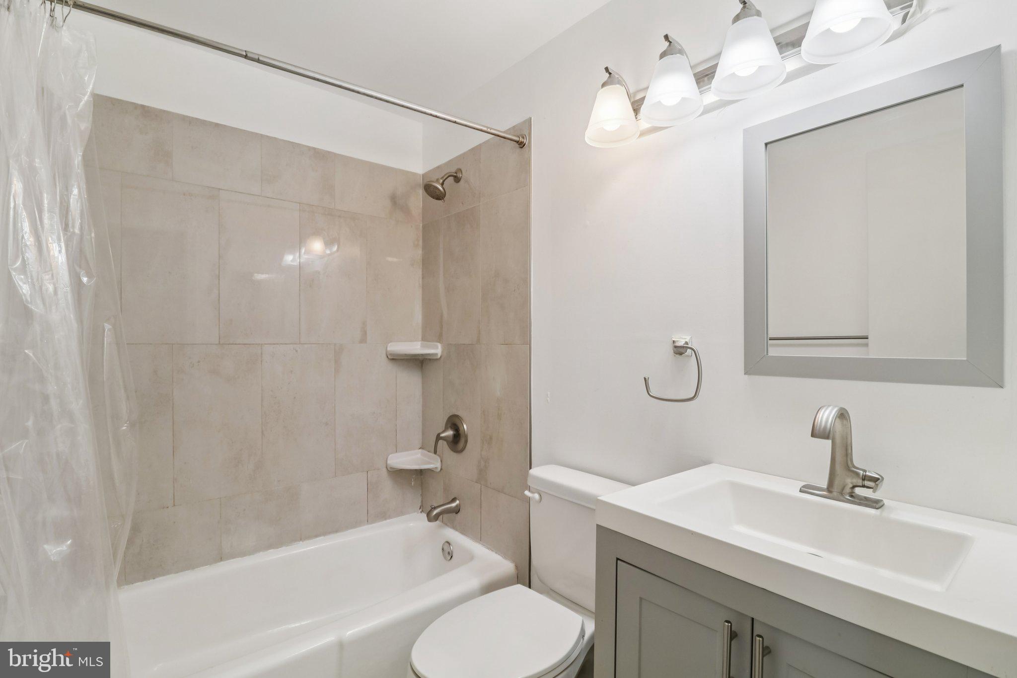 1456 Potomac Heights Drive, Unit 145 Fort Washington, MD 20744 - Photo 29 of 50 a bathroom with a sink toilet tub and shower