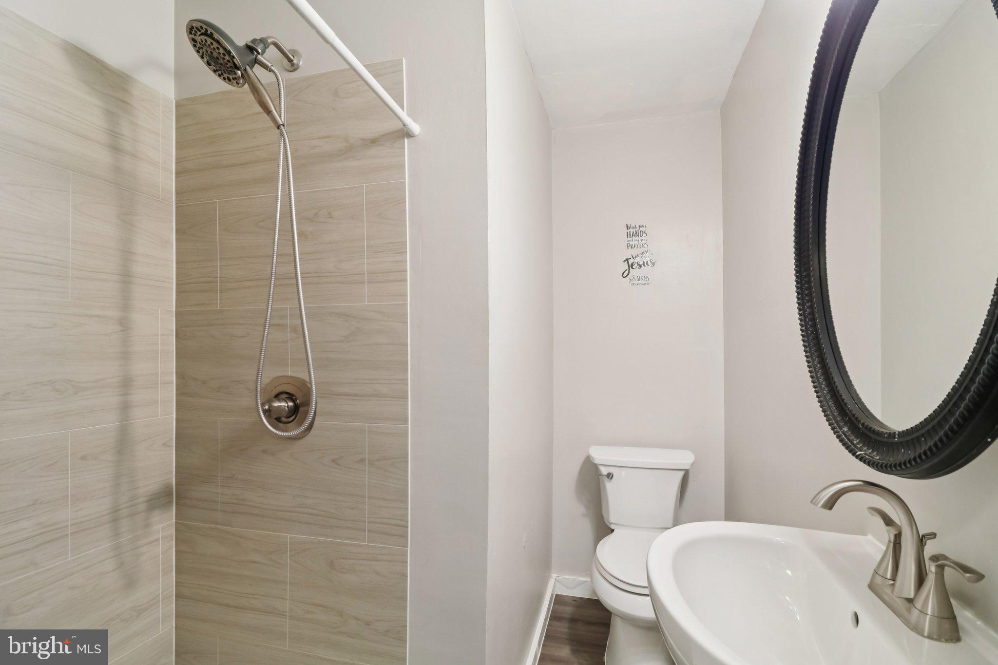 1456 Potomac Heights Drive, Unit 145 Fort Washington, MD 20744 - Photo 38 of 50 a bathroom with a sink a toilet and a mirror