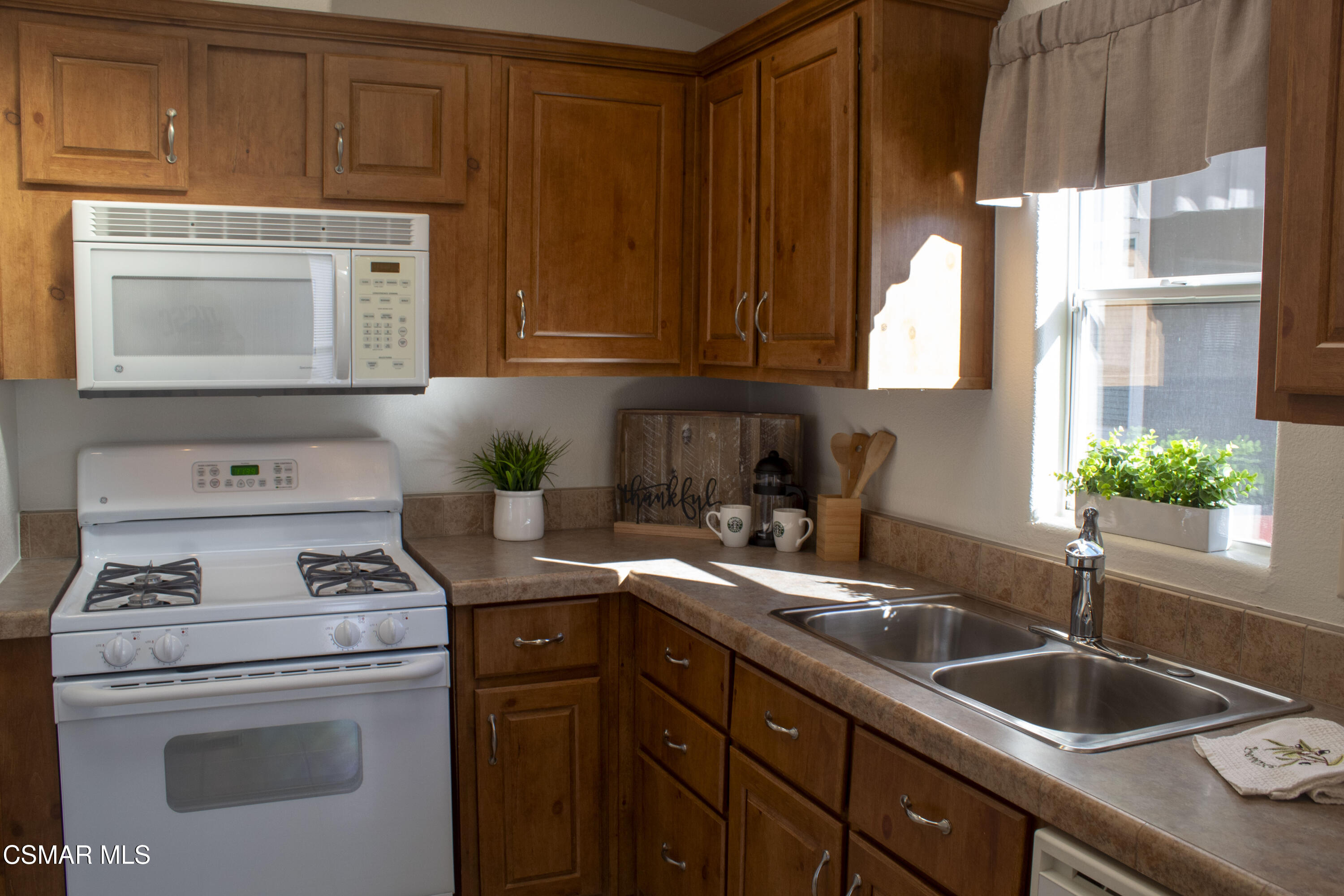 59 Farland Drive Thousand Oaks, CA 91320 - Photo 6 of 24 a kitchen with granite countertop a sink stove and cabinets